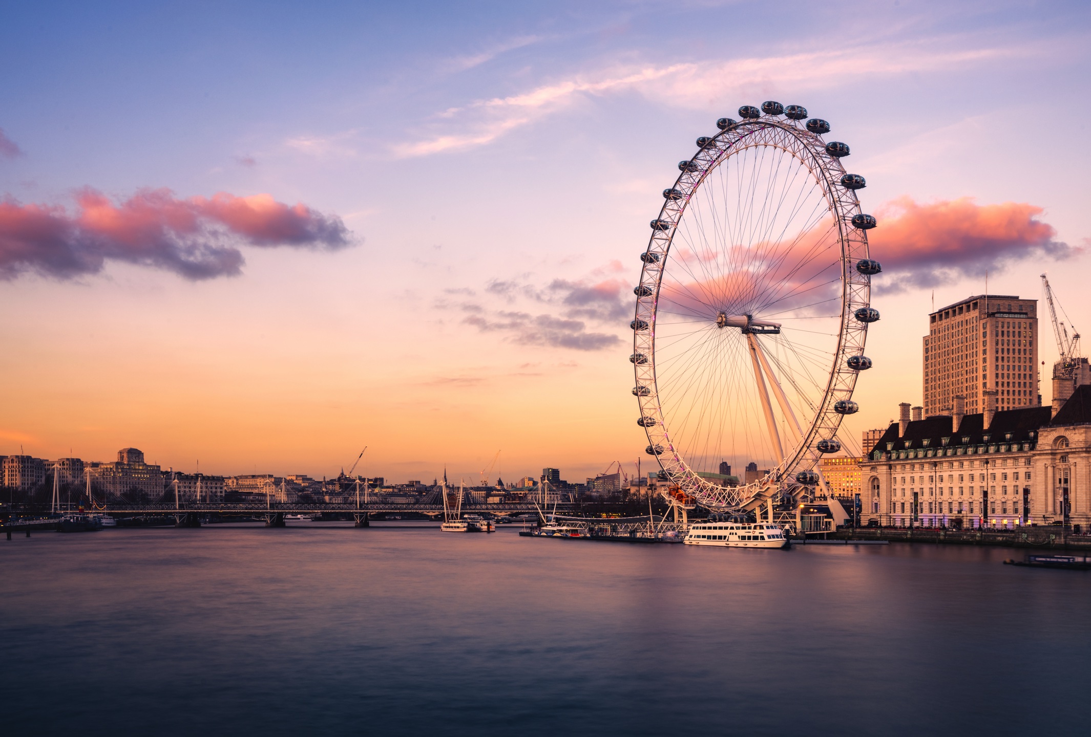 Photo of the London Eye in London, with a sunset in the background.