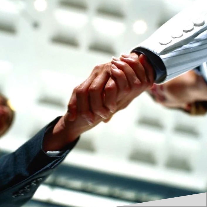 Photo of an insurance broker and customer shaking hands.